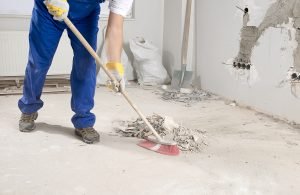 Construction Worker Sweeping Floor